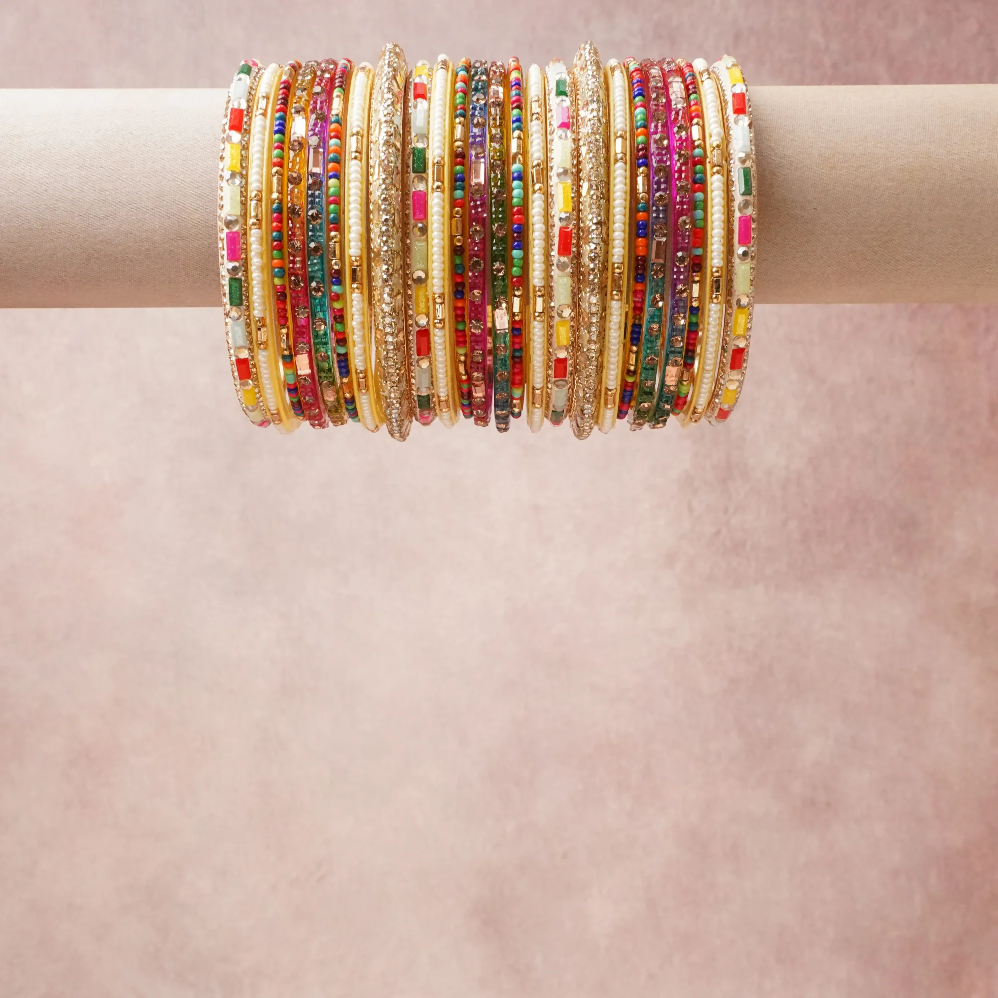 A grounding Gold forms the heart of the set, while touches of Gold, Cream, White, Ruby Red, Emerald Green, Sapphire Blue, Citrine Yellow, Tangerine Orange, Hot Pink add charm.

A thoughtful composition of Metal (Gold-toned alloy), Glass Beads, Faux Pearls, Enamel, Glass Rhinestones, designed to feel complete without being heavy.
Each element layers seamlessly, creating a look that is refined, wearable and quietly striking.